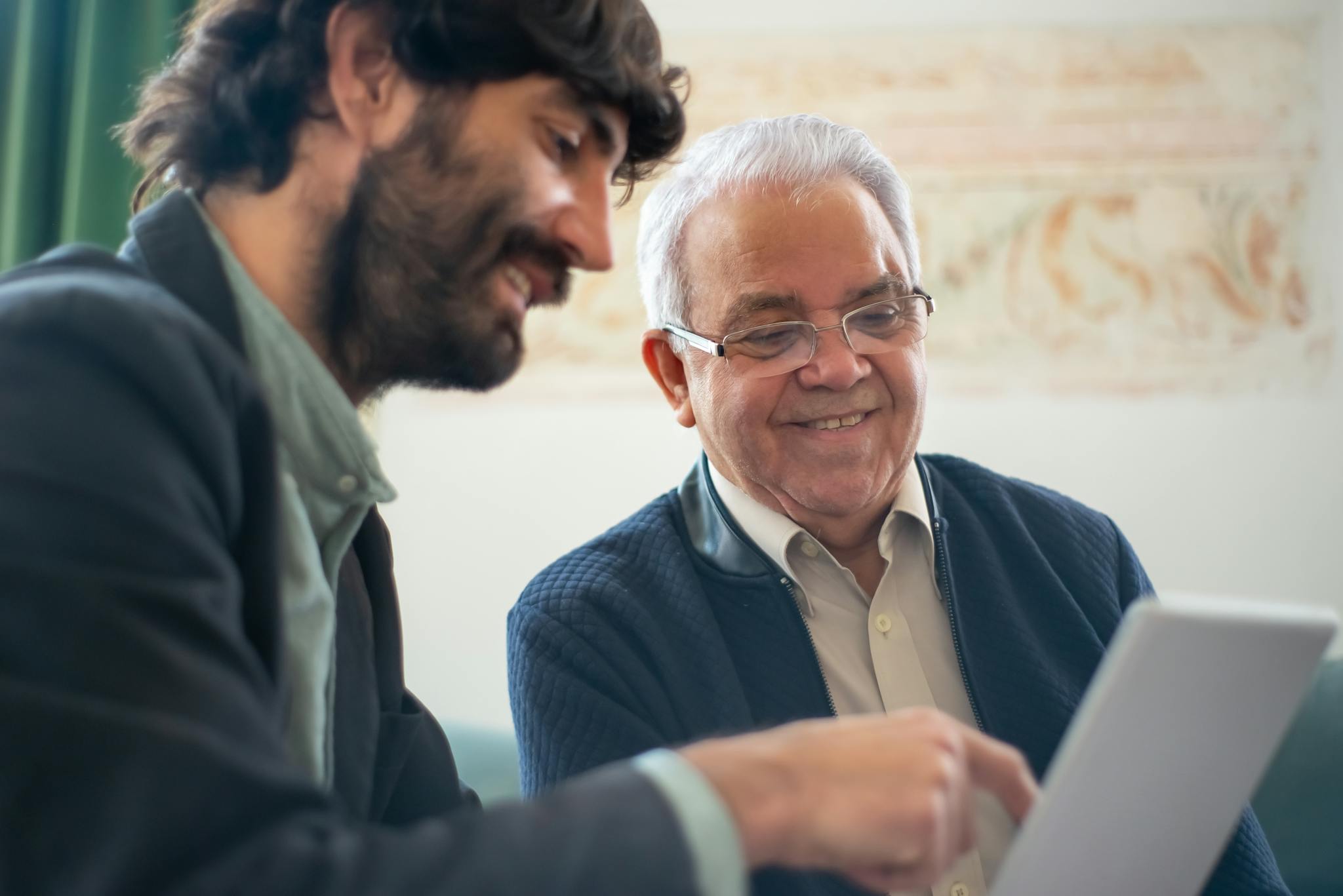 Elderly Man Discussing Business With A Younger